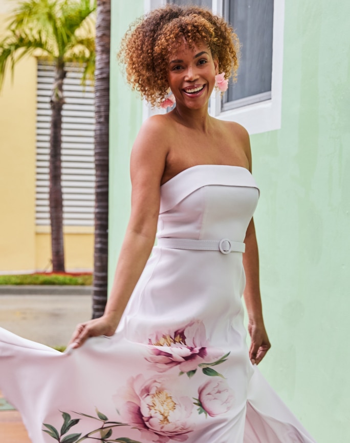 Woman in strapless floral maxi dress outdoors